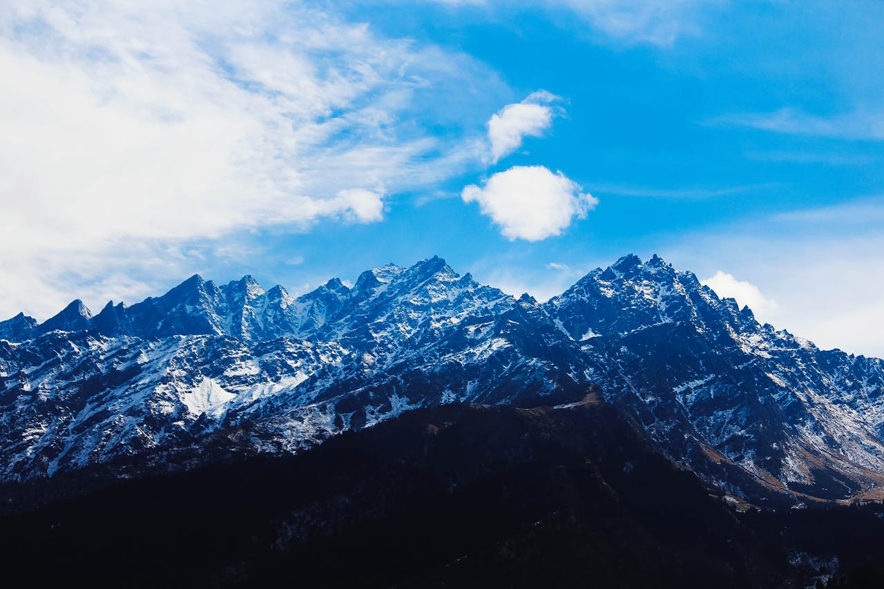 Stunning winter view of snow-covered Himalayan mountains under a bright blue sky.